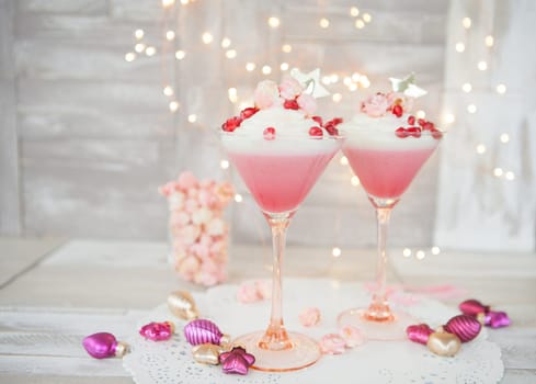 Cream dessert with popcorn and garnet apple in martini glass