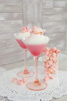Cream dessert with popcorn in a martini glass