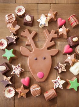 Various chocolates for Christmas on a wooden background