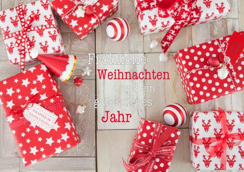 Red and white wrapped gifts for Christmas on wooden background