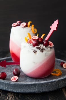 Delicious layered dessert in a glass with cranberry and orange