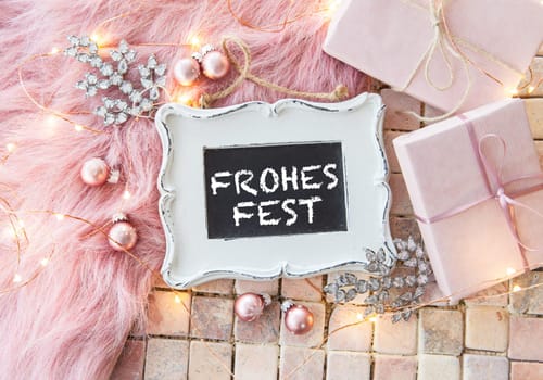 Colorful gifts and decoration for Christmas on background of stone and fur