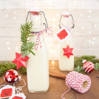 Bottle of egg punch with colorful decoration for Christmas