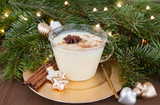 Cup of egg punch with cinnamon and anise for Christmas