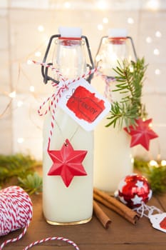 Bottle of egg punch with colorful decoration for Christmas