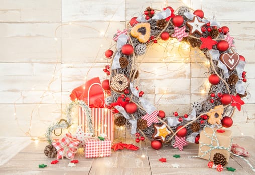 Colorful gifts and decoration for Christmas on a wooden background