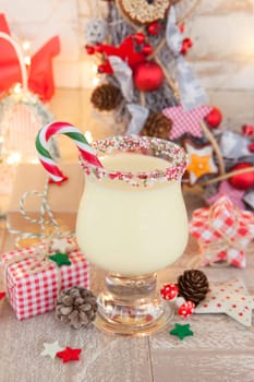 Egg punch with candy cane with colorful decoration for Christmas