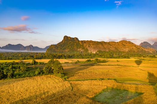 Aerial view of the fields and mountain. Beautiful landscape. Vang Vieng. Laos.
