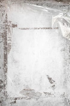 Grungy frame with remains of scotch tape and cellophane. Vertical background fully editable. It can be used as a poster, wallpaper, design t-shirts and more.