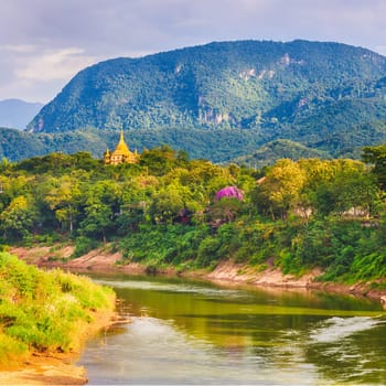 View of the river, temple and mountains. Beautiful landscape. Luang Prabang. Laos.