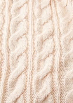 Knitted braid pattern in wool white as background with text space