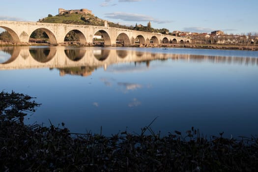 Medellin old bridge and castle from Guadiana riverside, Spain