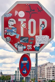 Sticker-covered stop sign on the roadside in downtown Berlin