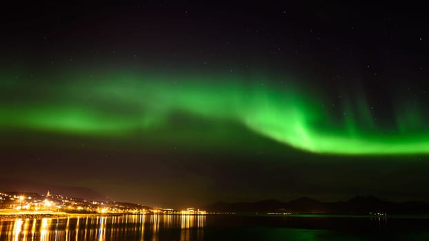 A beautiful green Aurora borealis or northern lights in the sky at Tromso, Norway