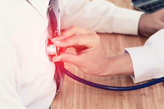 doctor hand holding stethoscope in front of patient chest, listen heartbeat, healthcare concept
