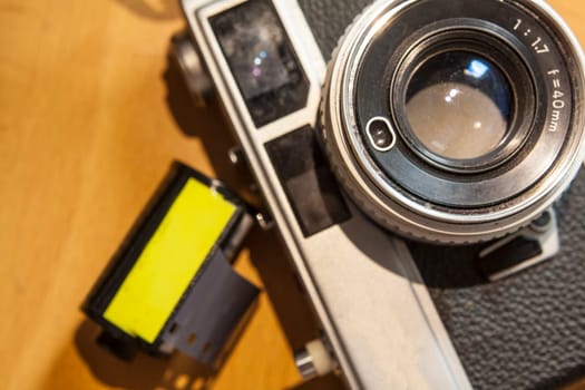 Old film SLR and TLR cameras over wooden background
