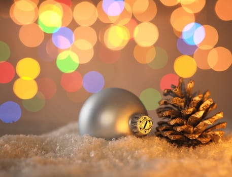 Colorful romantic Christmas background with a pine cone in snow