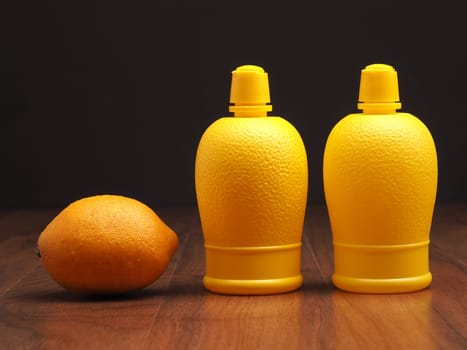 Lemon fruit with lemon juice on a wooden table