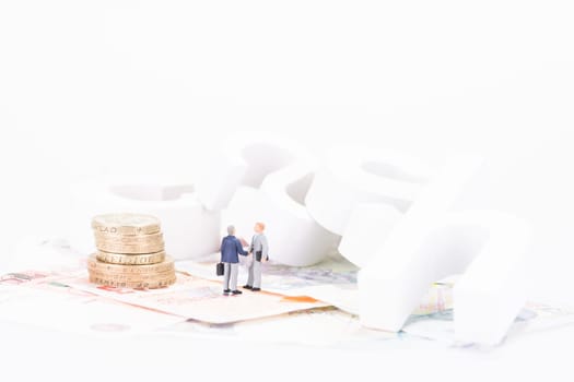 Miniature businessman shaking hands close up