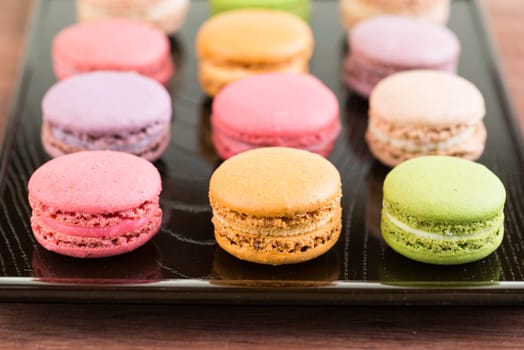 Macarons on a lacquer tray close up