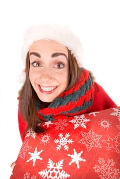 Happy and beautiful girl with freckles in Christmas holding a present