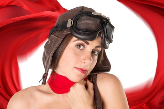 Beautiful girl with freckles wearing helmet, goggles and a red scarf