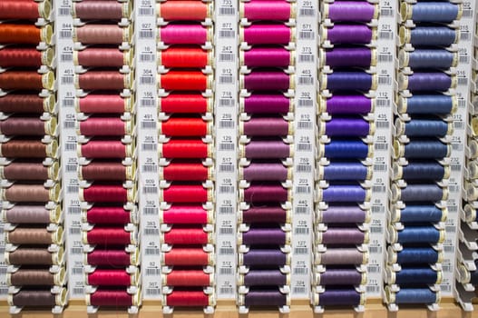 Badajoz, Spain - August 30th, 2017: sewing thread reels on a market stall. Typical background on a notions store