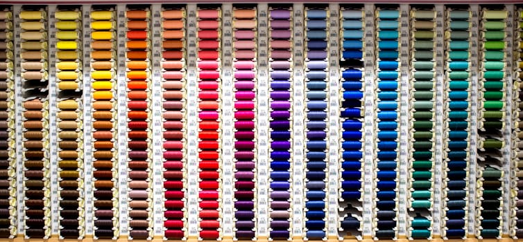 Badajoz, Spain - August 30th, 2017: sewing thread reels on a market stall. Typical background on a notions store