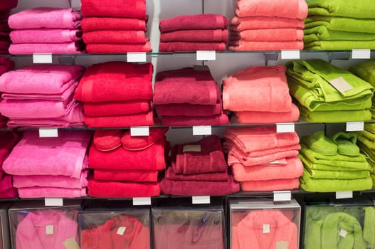 Towels, slippers and bath robes on shelves. Bath clothes stand