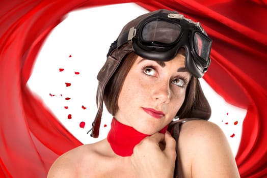Beautiful girl with helmet and goggles and red rose petals