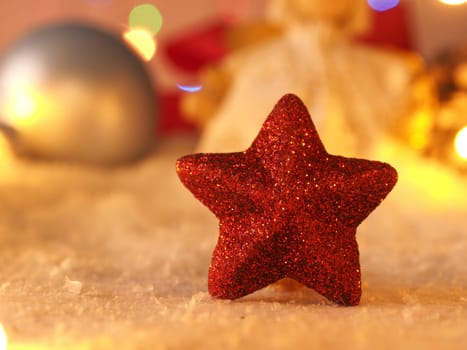Close up of a red star shape in snow, Christmas background