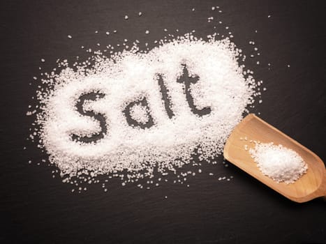 Organic salt on a dark slate board, food concepts