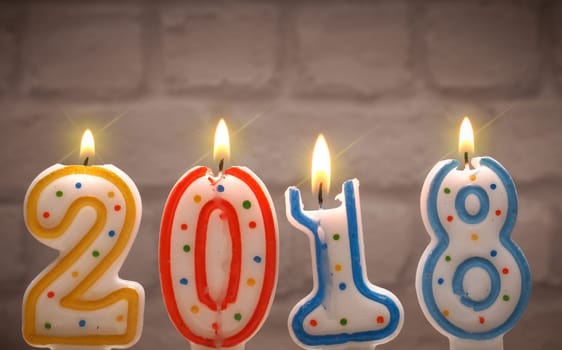 Burning candles with the number 2018, New Years concept background
