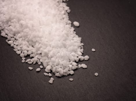 Organic salt on a dark slate board, food concepts