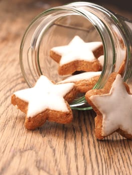 Star shaped cinnamom cookies on a wooden table, close up, Christmas sweets