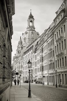 Street in the old town of Dresden. In the background is the rebuilt Frauenkirche