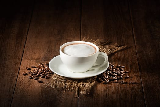 Coffee cup of cappuccino on wooden rustic background