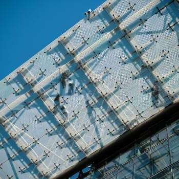 Fitters on a glass roof on a construction site in Berlin