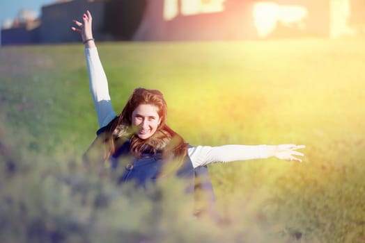 Beautiful and happy young girl posing outdoors