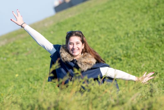 Beautiful and happy young girl posing outdoors