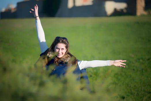 Beautiful and happy young girl posing outdoors