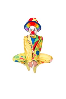 Young girl with clown costume jumping isolated in white