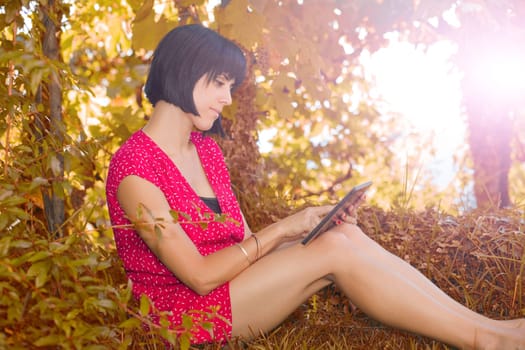 casual woman working with a tablet pc, outdoor