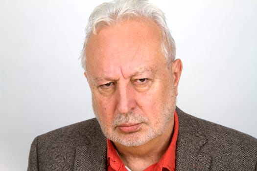 Unfriendly senior on a bright background