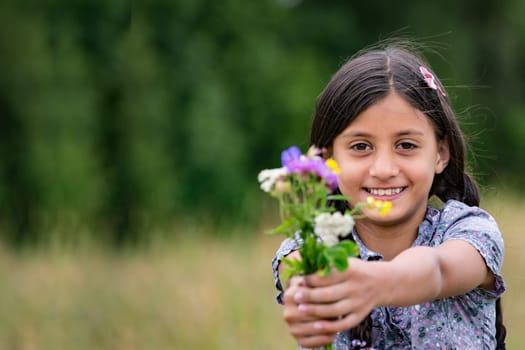 Pretty girl with self-picked bouquet of flowers