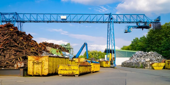Site of a scrap yard with container and crane