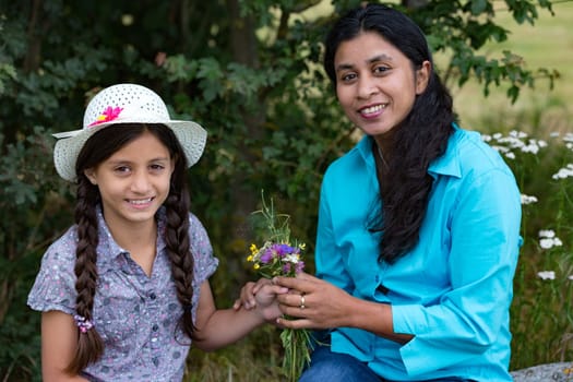 Girl gives mother a self-puffed bouquet of flowers