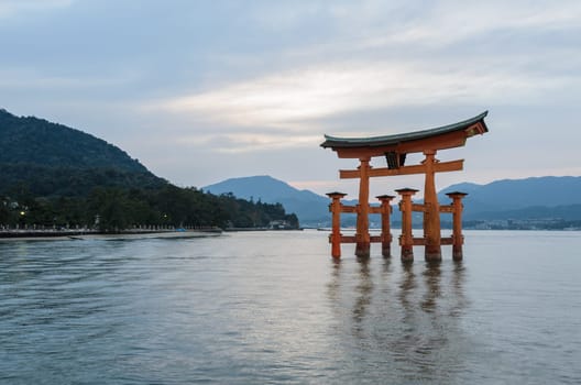 The stunning sunset view of famous floating torii gate of the Itsukushima Shrine in Miyajima, Hiroshima, Japan