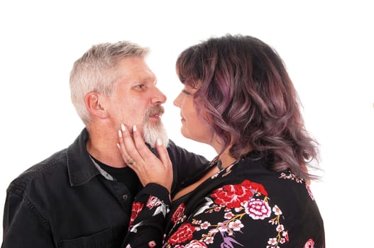 A middle age couple in a loving gesture in a close-up image, isolated for.white background.