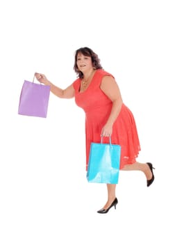A woman in a red dress holding her shopping bags and running.in heels, isolated for white background.